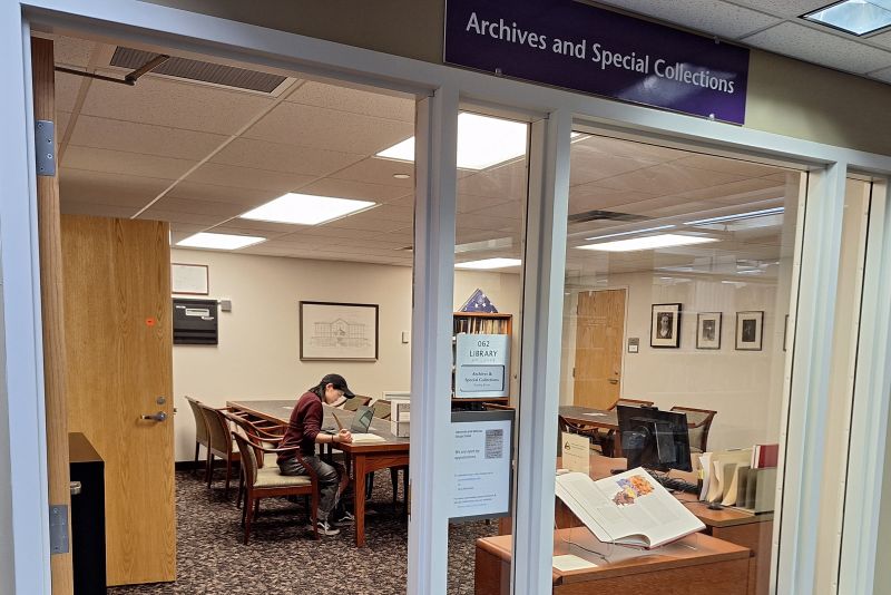 Archives and Special Collections Reading Room front entrance with researcher working at table